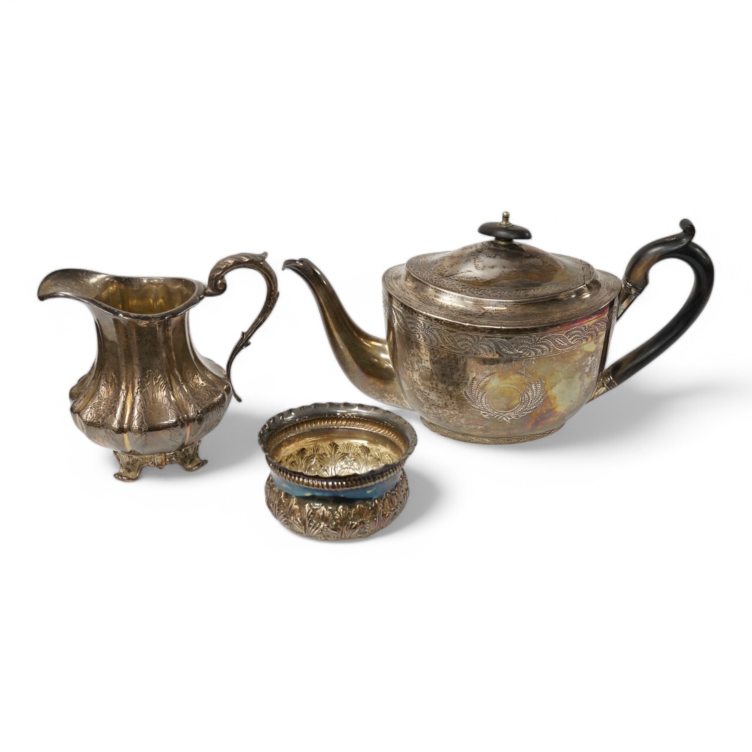 A George III engraved silver oval teapot, by John Eames, London, 1803, together with an early Victorian engraved silver milk jug, Edward Barton, London, 1837 and a late Victorian embossed silver sugar bowl by Josiah Will